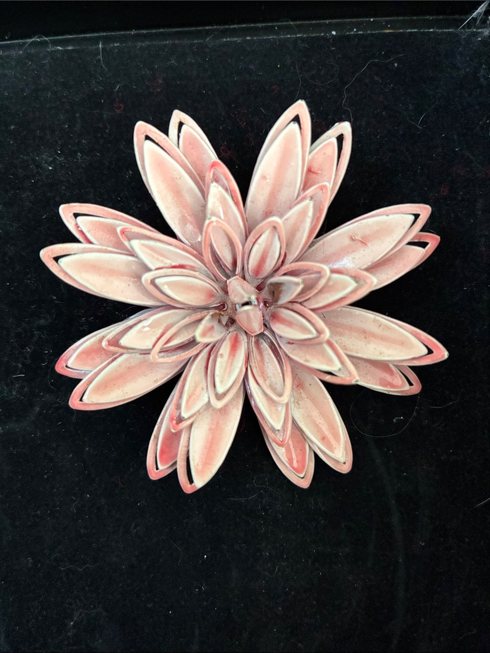 This is a vintage 1960s 3D multi-layered pink enamel dahlia flower brooch.